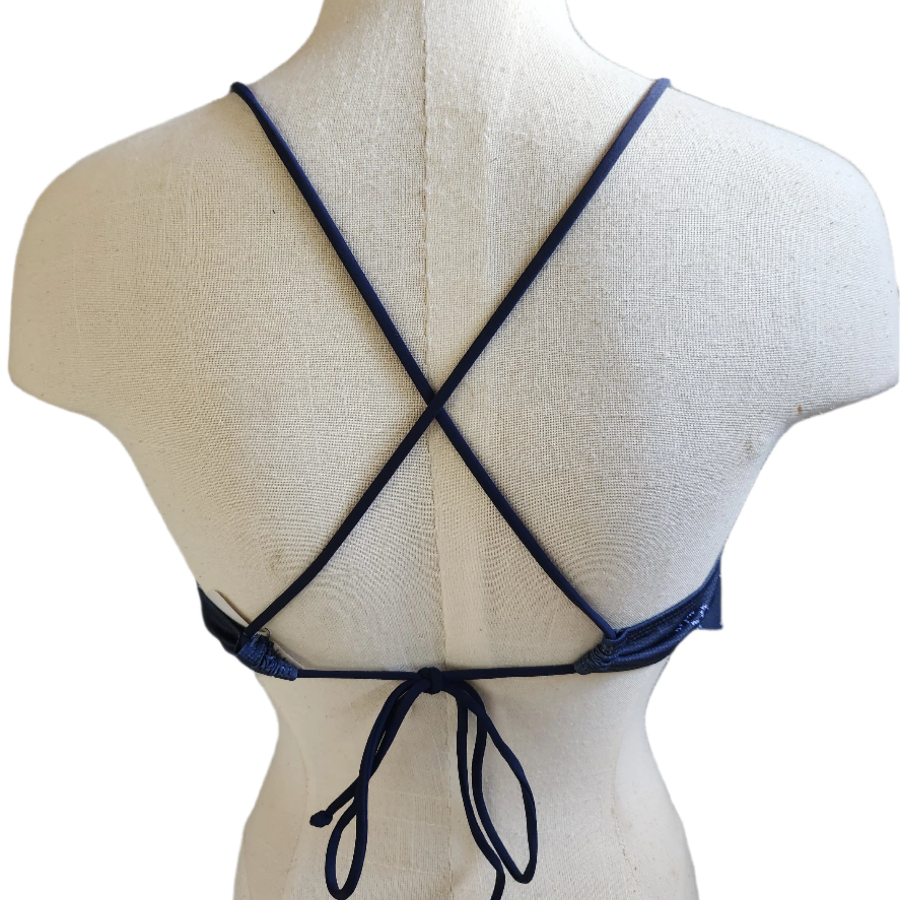A navy blue floral stitch flounce crop top displayed on a mannequin