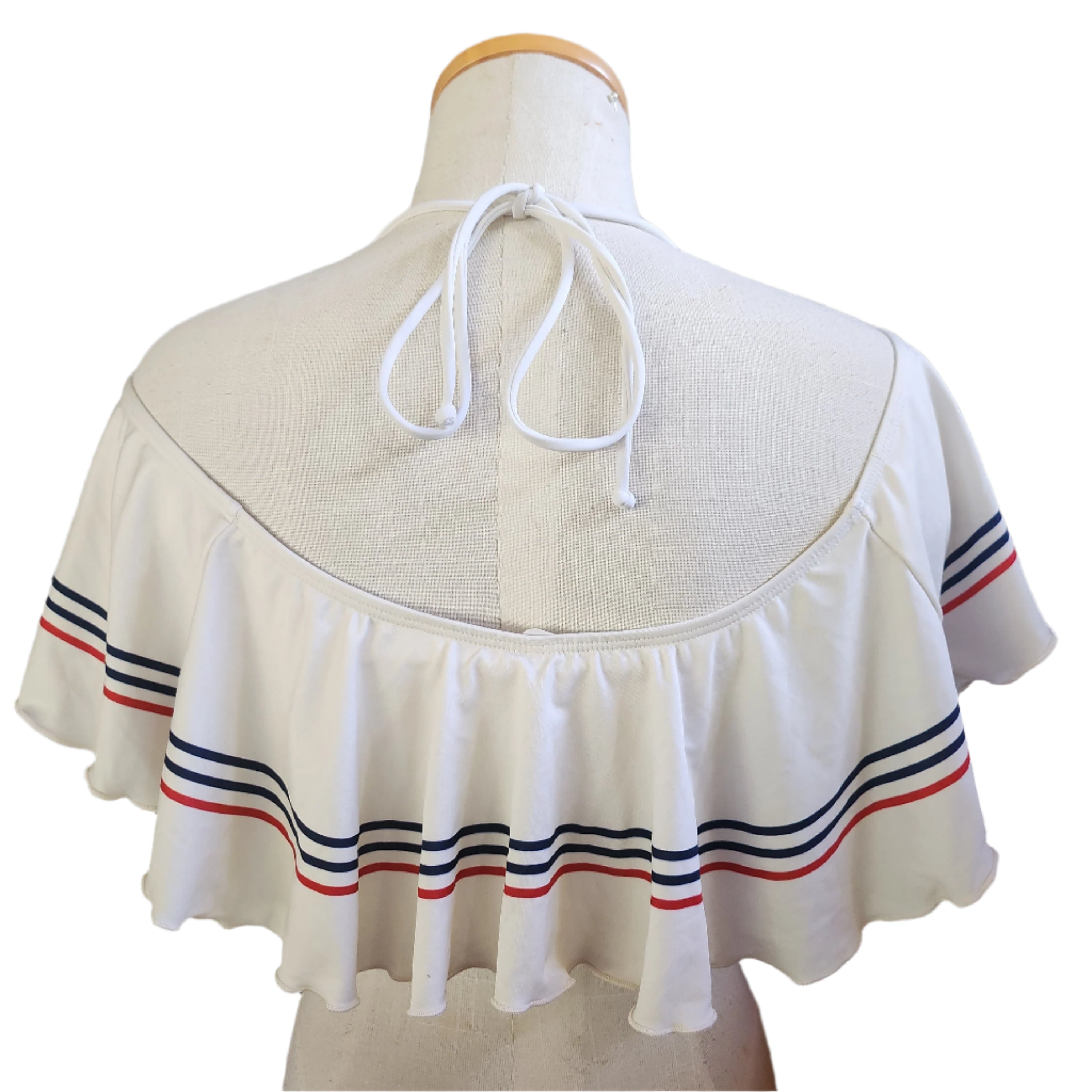 White bandeau top with red and blue stripes on a mannequin against a white background.