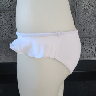 Navy blue bikini bottom on a mannequin against a gray tiled wall.