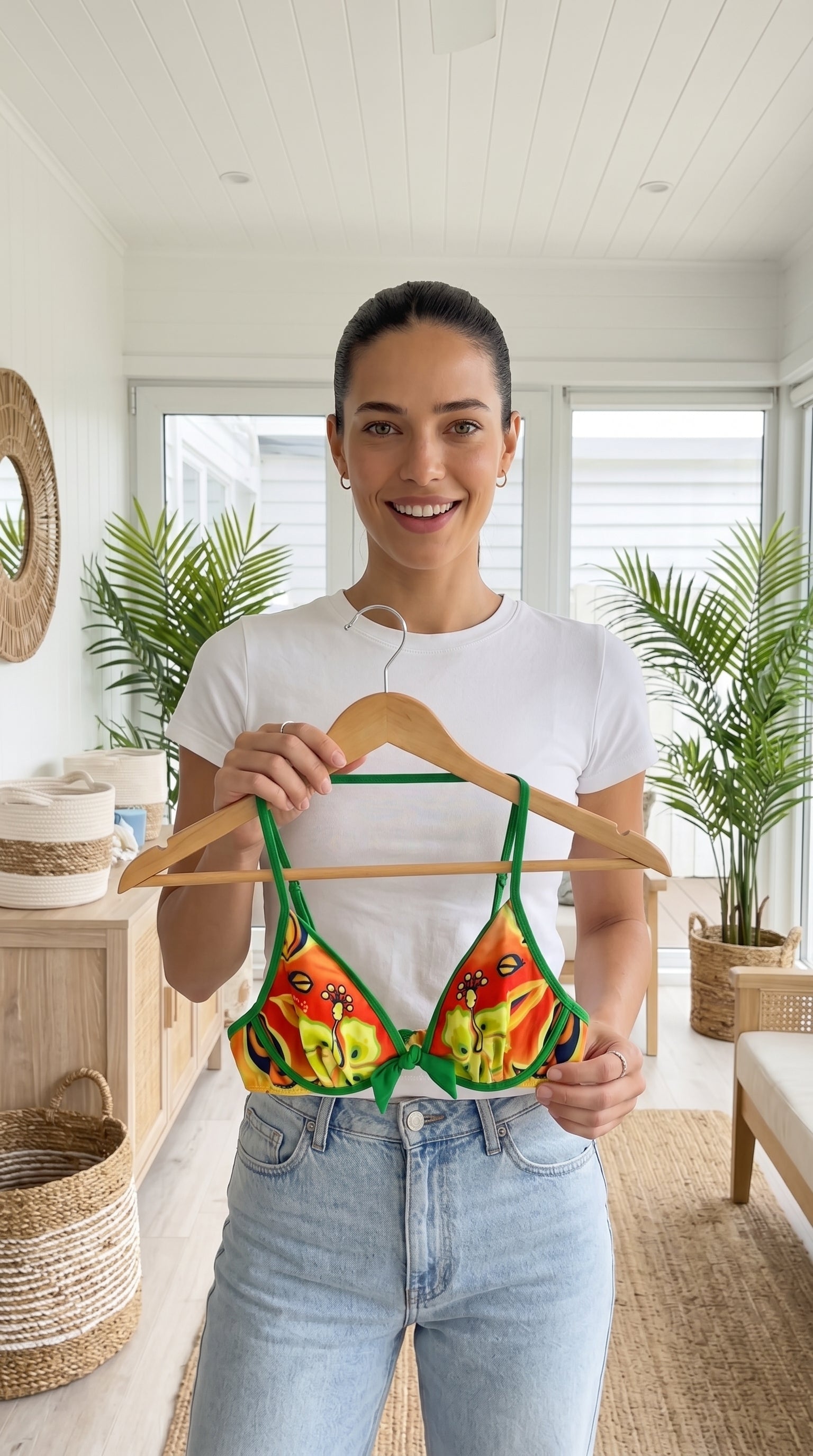 Woman wearing a colorful bikini with floral design on a white background