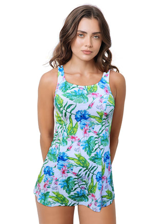 Woman wearing a tropical patterned one-piece swim dress against a white background.