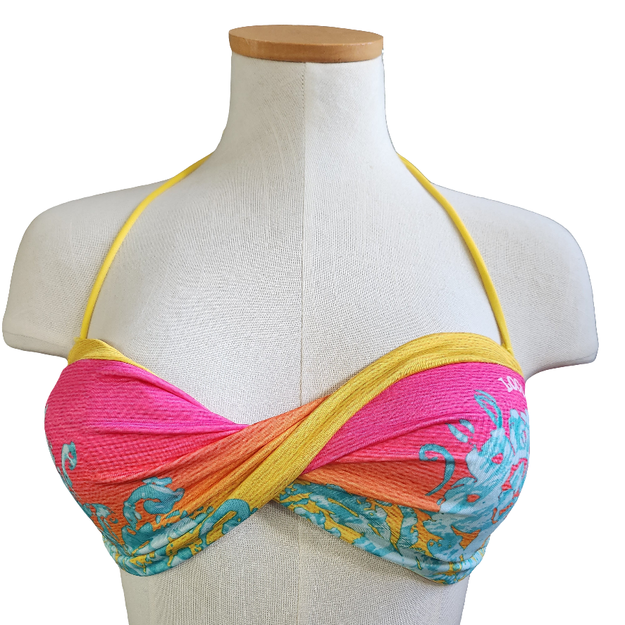 Colorful bikini top on a mannequin with a white background