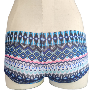 Blue and pink patterned shorts on a mannequin against a white background