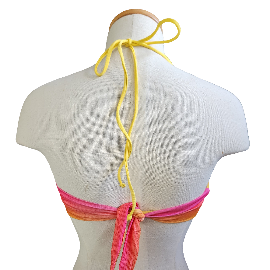 Colorful bikini top on a mannequin with a white background