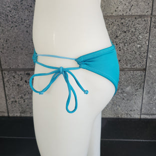 Blue bikini bottom on a mannequin against a white background