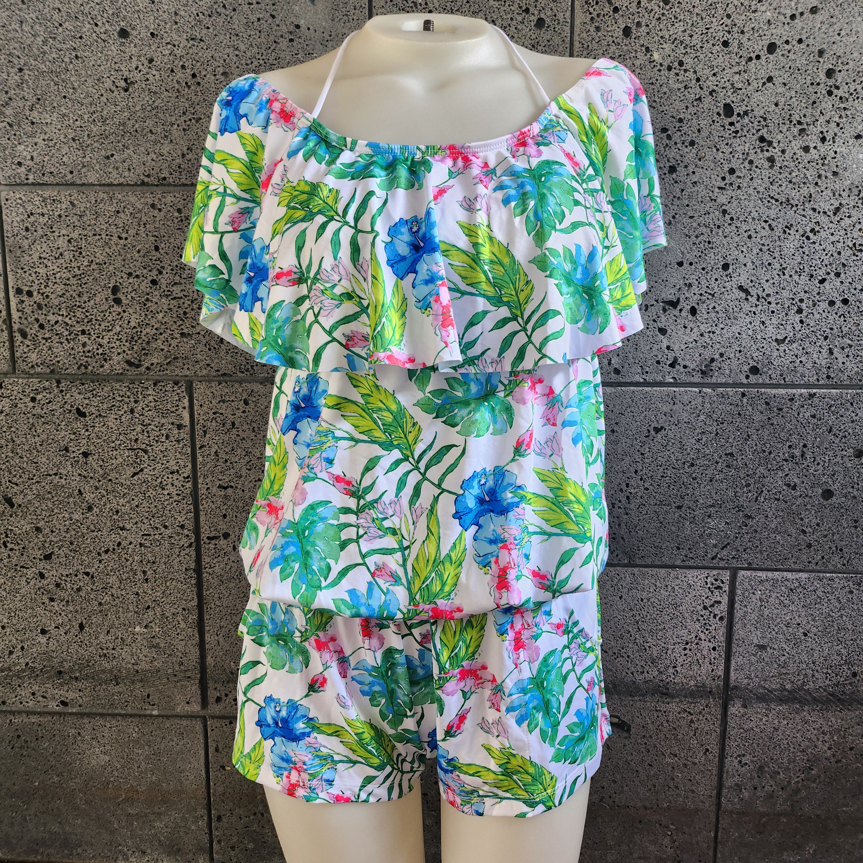 Mono con hombros descubiertos en color agua