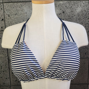 Navy and white striped bikini on a mannequin against a tiled floor background