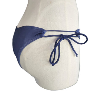Blue bikini bottom on a mannequin against a white background