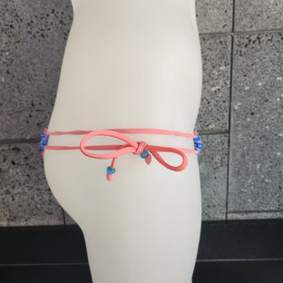 This image features the Loco Boutique Paisley Keyhole Front Bikini Top, designed with a striking paisley print in shades of teal blue, pink, purple, and gold. The bikini top is tailored with adjustable slide cups and tie-back strings, providing a customizable fit and coverage.