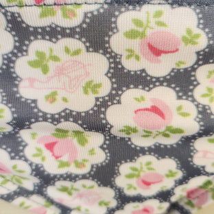 Floral bikini bottom on a mannequin against a stone wall background