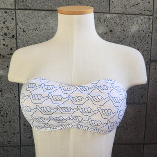 This image displays a stylish and playful bikini set from Loco Boutique, featuring a vibrant aloha-themed print. The bikini top is designed as a bandeau-style, enhancing a chic and modern look.