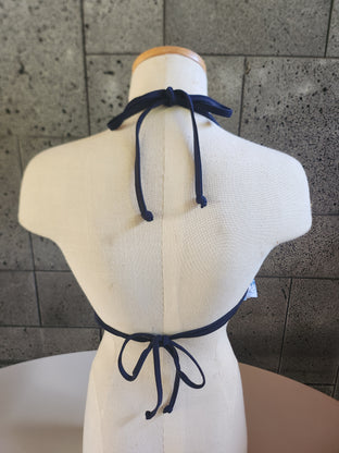 A mannequin displaying a blue and white floral print halter top with underwire and a flounce front.
