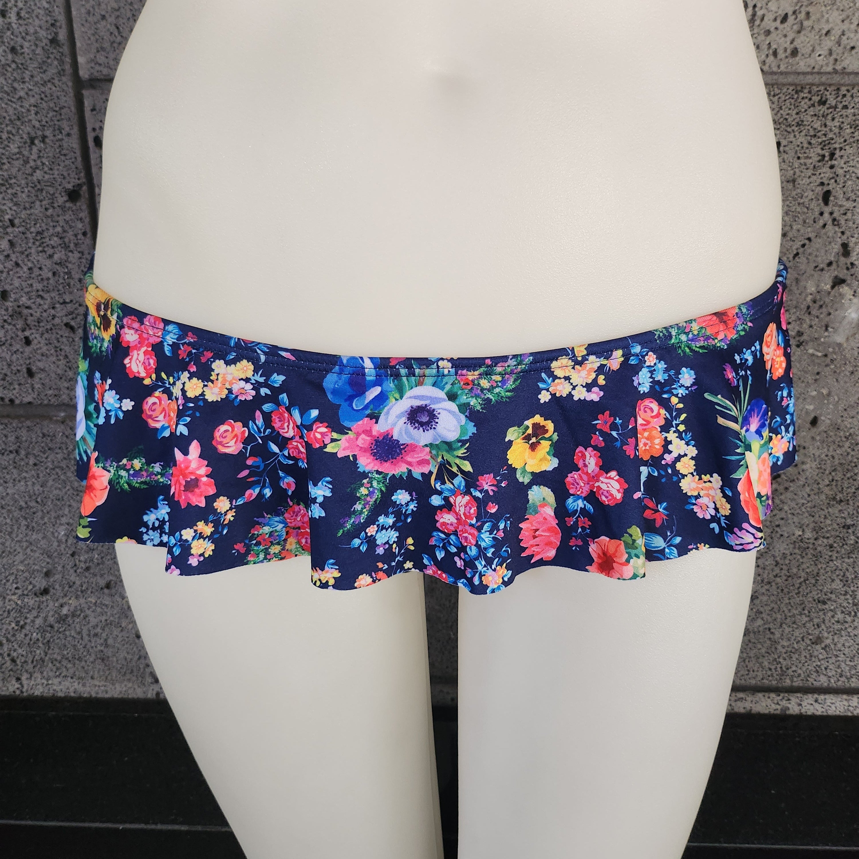 Floral-patterned underwear on a mannequin against a dark background